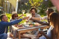 Group Of Friends Enjoying Outdoor Picnic In Garden