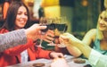 Group of friends enjoying red wine in speakeasy vintage bar - Young people hands cheering with wine and having fun hanging out - Royalty Free Stock Photo