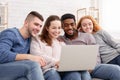 Group of friends enjoying time together and looking at laptop Royalty Free Stock Photo