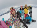 Group of friends with equipment taking selfie at resort. Winter vacation Royalty Free Stock Photo