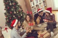 Group of friends exchanging Christmas presents Royalty Free Stock Photo