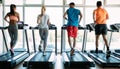 Group of friends exercising on treadmill machine