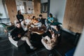 Group of friends gathering and enjoying music in a cozy living room