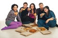 Group of friends giving pieces of pizza Royalty Free Stock Photo