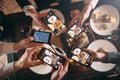 Group of friends going out and taking a photo of food together with mobile phone Royalty Free Stock Photo