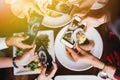 Group of friends going out and taking a photo of Italian food together with mobile phone. Royalty Free Stock Photo