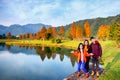 Group of friends hang out along beautiful lake