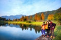 Group of friends hang out along beautiful lake