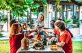 Group of friends having fun at bbq dinner outdoor in garden restaurant Royalty Free Stock Photo