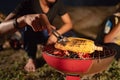 Group of friends having fun camping, making roasted corn Royalty Free Stock Photo