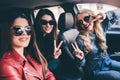 Group of friends having fun on the car. Singing and laughing in the city Royalty Free Stock Photo