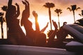 Group of friends having fun in convertible car during road trip at sunset - Young travel people driving a cabriolet