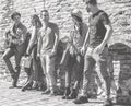 Group of friends having fun playing music with guitar outdoor in old city town - Young people in social moment laughing together Royalty Free Stock Photo