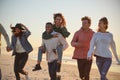 Group Of Friends Having Fun Running Along Winter Beach Together Royalty Free Stock Photo