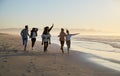 Group Of Friends Having Fun Running Along Winter Beach Together Royalty Free Stock Photo