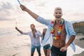 Group of friends having fun running on the beach with sparklers Royalty Free Stock Photo