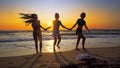 Group of friends having fun running down the beach Royalty Free Stock Photo