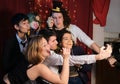 Group of friends having fun and taking a selfie at a Christmas party Royalty Free Stock Photo