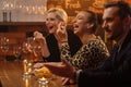 Group of friends having fun talk behind bar counter in a cafe