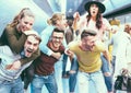 Group of friends having fun in underground metropolitan station - Young people hanging out ready for party night  - Friendship and Royalty Free Stock Photo