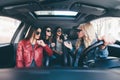 Group of friends having fun whet drive the car. Singing and laughing on the road Royalty Free Stock Photo