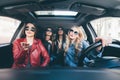 Group of friends having fun whet drive the car. Singing and laughing on the road Royalty Free Stock Photo