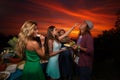 Friends having Ã¢â¬â¹furshet in the backyard at summer sunset. Young woman quietly is feeding her boyfriend