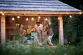 A group of friends having a good time at birthday party at the cottage porch. Vacation, nature, cottage, celebration