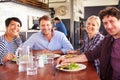 A group of friends having lunch in a restaurant Royalty Free Stock Photo