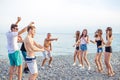 Friends dance on beach under sunset sunlight, having fun, happy, enjoy Royalty Free Stock Photo