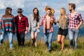 Group of friends hikers walking in mountains. Young men and women on camping. Countryside hiking. Group of friends on