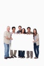 Group of friends holding blank sign together Royalty Free Stock Photo