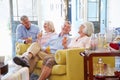 Group Of Friends At Home Relaxing In Lounge With Cold Drinks Royalty Free Stock Photo