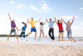 Group of friends jumping on the beach Royalty Free Stock Photo