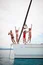 Group of friends jumping in the water during a boat Royalty Free Stock Photo