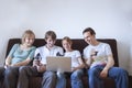 Group of friends laughing with laptop Royalty Free Stock Photo