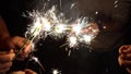 A group of friends lit sparklers together. People get ready for the holiday and light Bengal fires. The company of Royalty Free Stock Photo