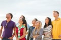 Group of friends looking up on the beach