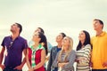 Group of friends looking up on the beach