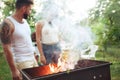 Group of friends making barbecue in the backyard. concept about good and positive mood with friends Royalty Free Stock Photo