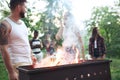 Group of friends making barbecue in the backyard. concept about good and positive mood with friends Royalty Free Stock Photo