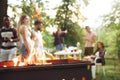 Group of friends making barbecue in the backyard. concept about good and positive mood with friends Royalty Free Stock Photo