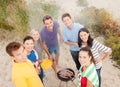 Group of friends making barbecue on the beach