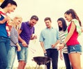 Group of friends making barbecue on the beach