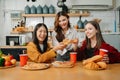 Group of friends making fun at home party.They sitting on desk in living room and eating pizza. happy Royalty Free Stock Photo