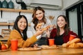 Group of friends making fun at home party.They sitting on desk in living room and eating pizza. happy Royalty Free Stock Photo