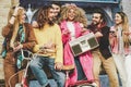 Group of friends making party listening to music with vintage boombox - Happy young people having fun outdoor