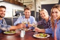 A group of friends making a toast at a restaurant, portrait Royalty Free Stock Photo