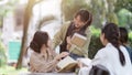 Group of friends meet in the park in university. People having breaking time outdoor. young woman greet college