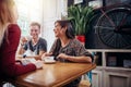 Group of friends meeting at cafe and drinking coffee or tea, chatting and laughing Royalty Free Stock Photo